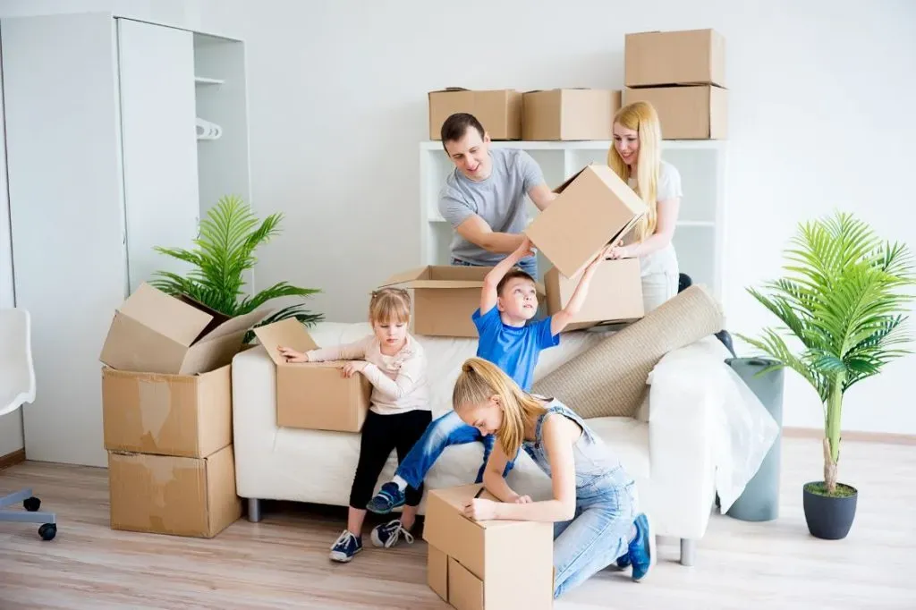 A family unpacking boxes in their new living room